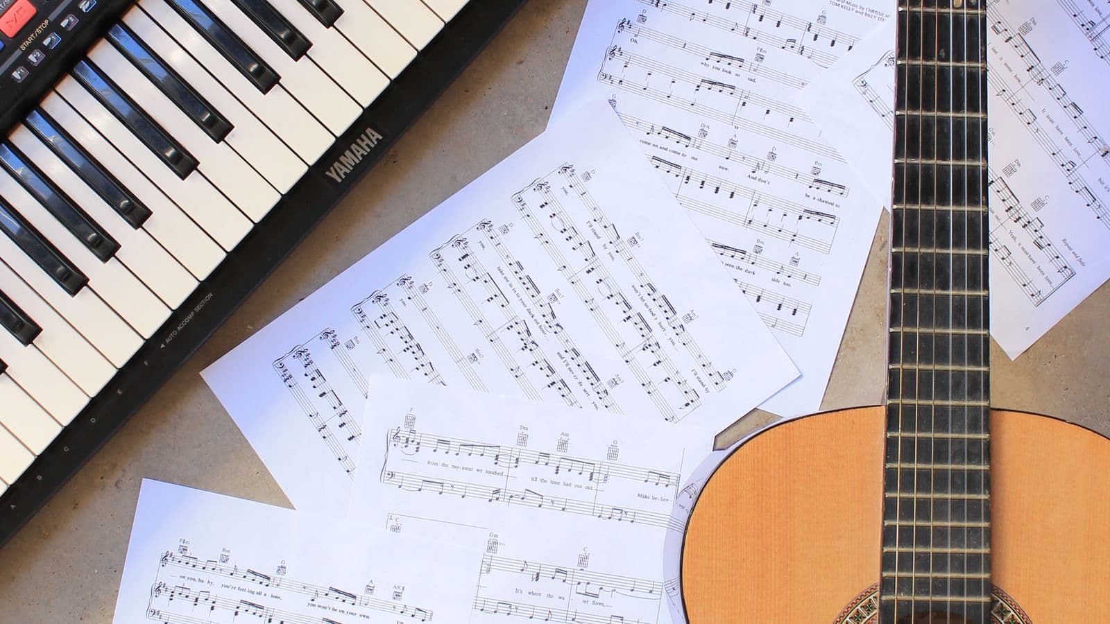 Klasična gitara, notni listovi i klavijatura